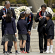 Children give lei necklaces to G7 foreign ministers who visited Hiroshima.